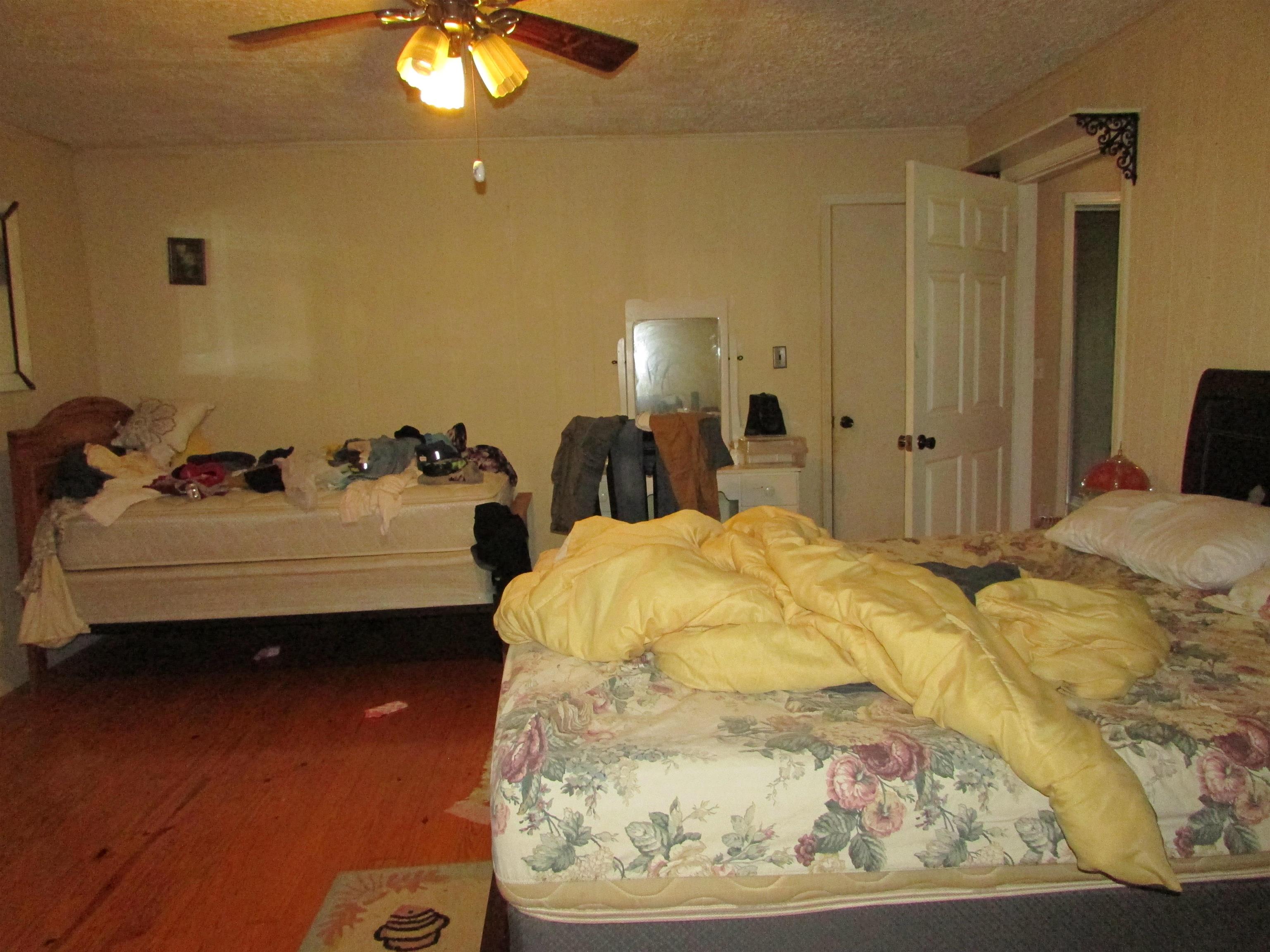 139 Plunk Drive Adamsville, TN 38310 - Photo 12 of 25 a spacious bedroom with a bed and chandelier