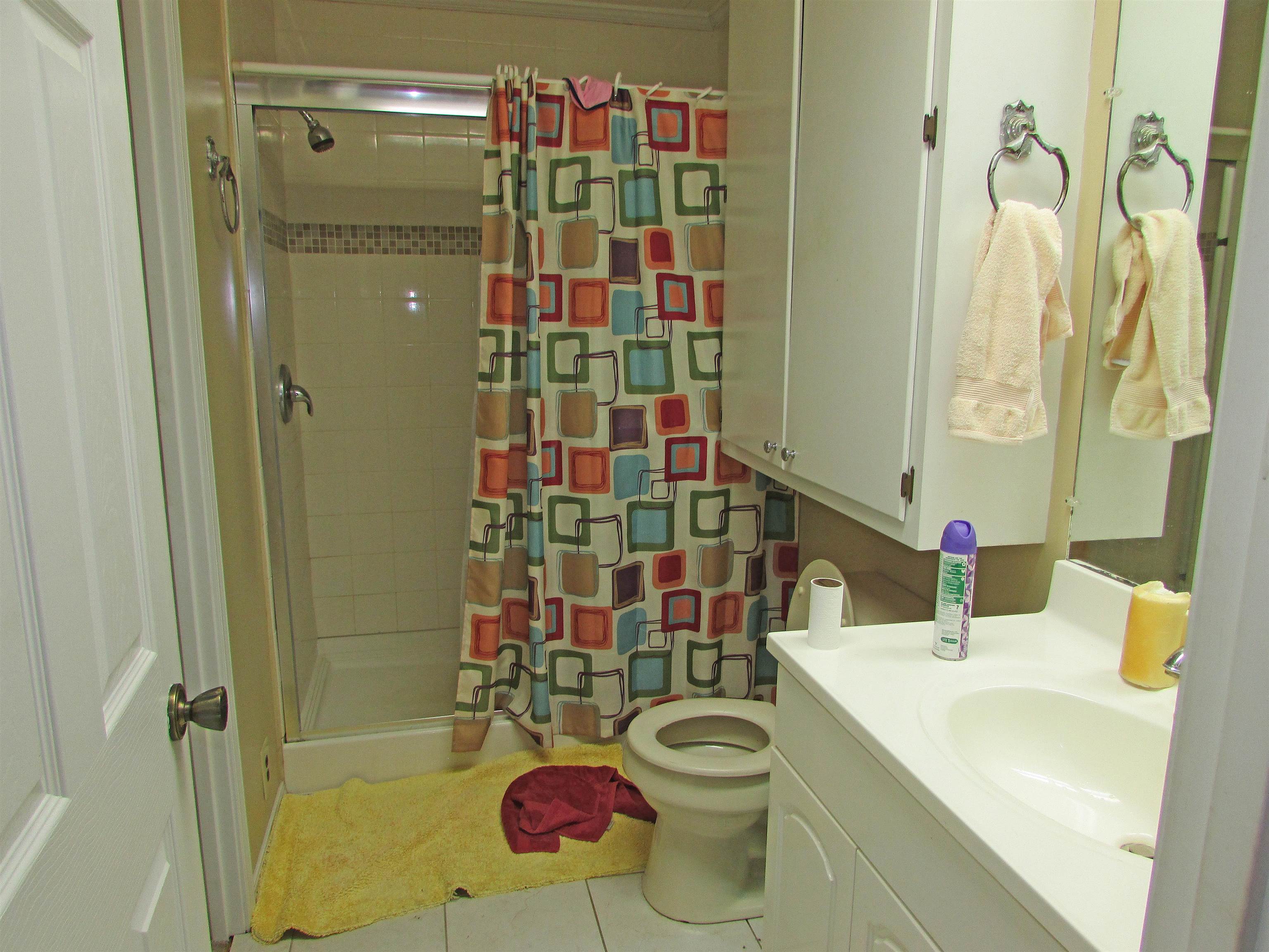 139 Plunk Drive Adamsville, TN 38310 - Photo 14 of 25 a bathroom with a sink toilet and shower