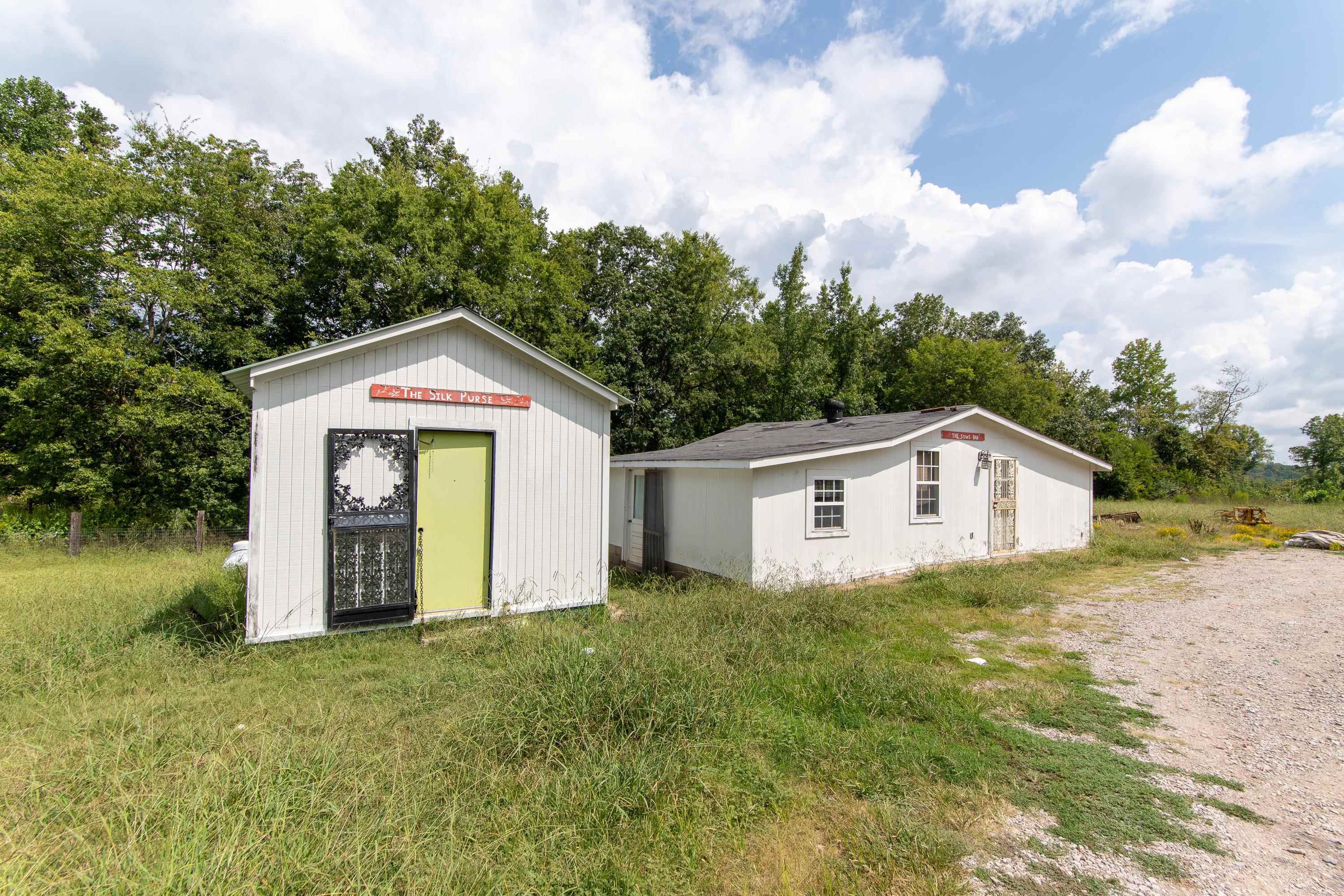 139 Plunk Drive Adamsville, TN 38310 - Photo 21 of 25 a front view of a house with a yard and garage