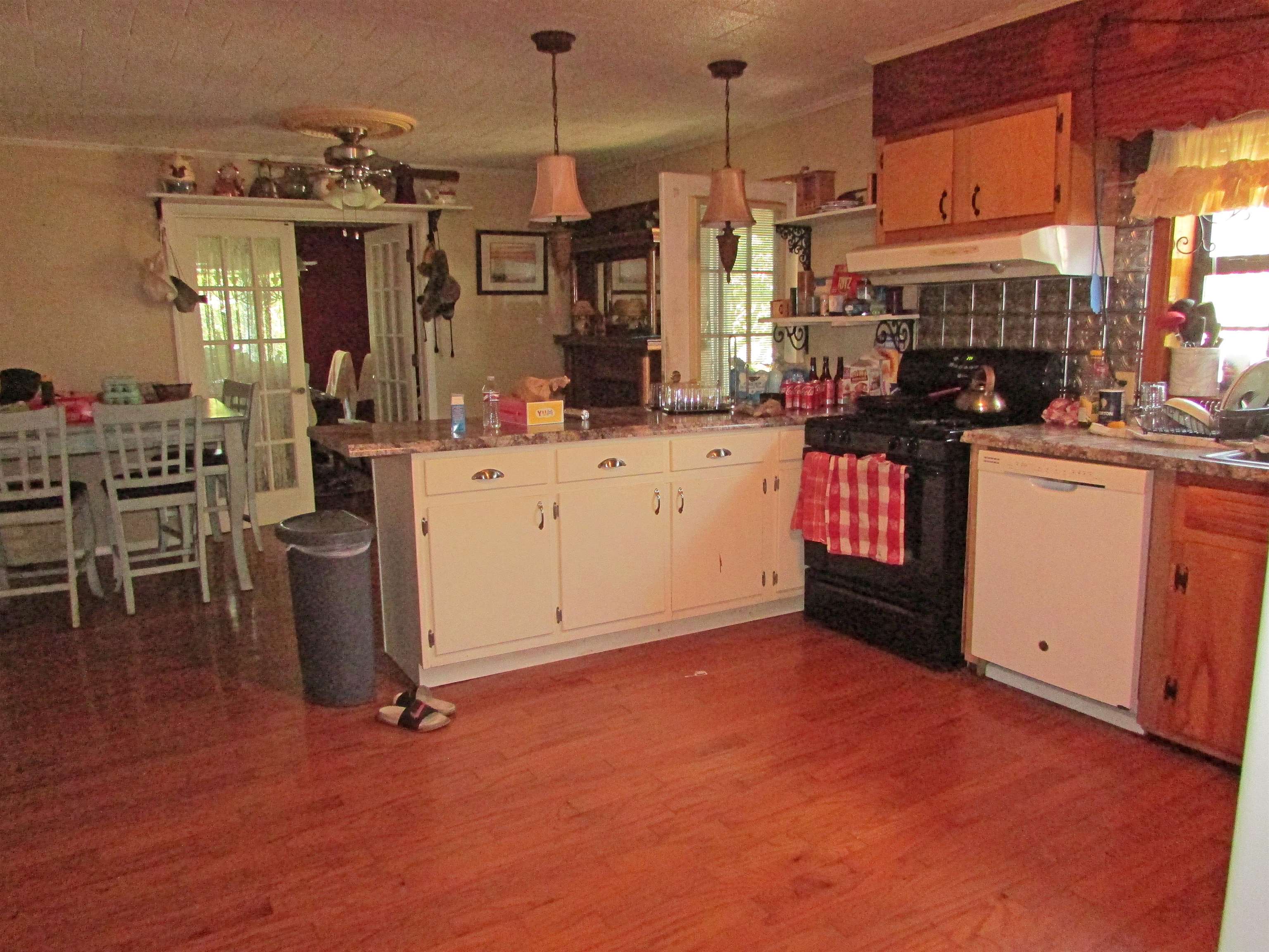 139 Plunk Drive Adamsville, TN 38310 - Photo 3 of 25 a view of kitchen and dining room with wooden floor