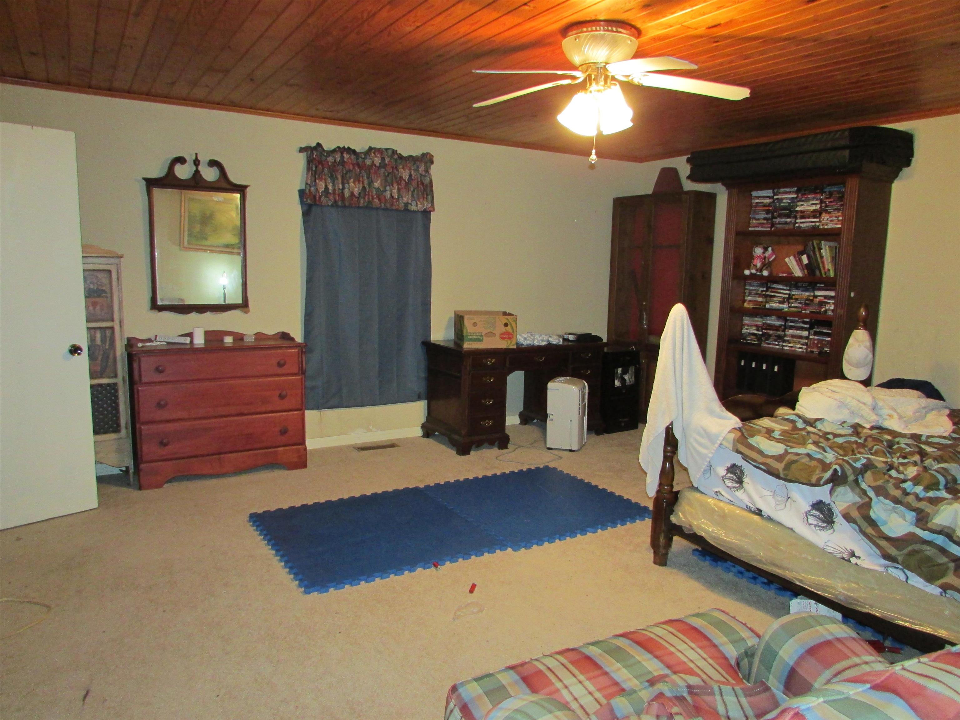 139 Plunk Drive Adamsville, TN 38310 - Photo 9 of 25 a bedroom with a bed and wooden floor