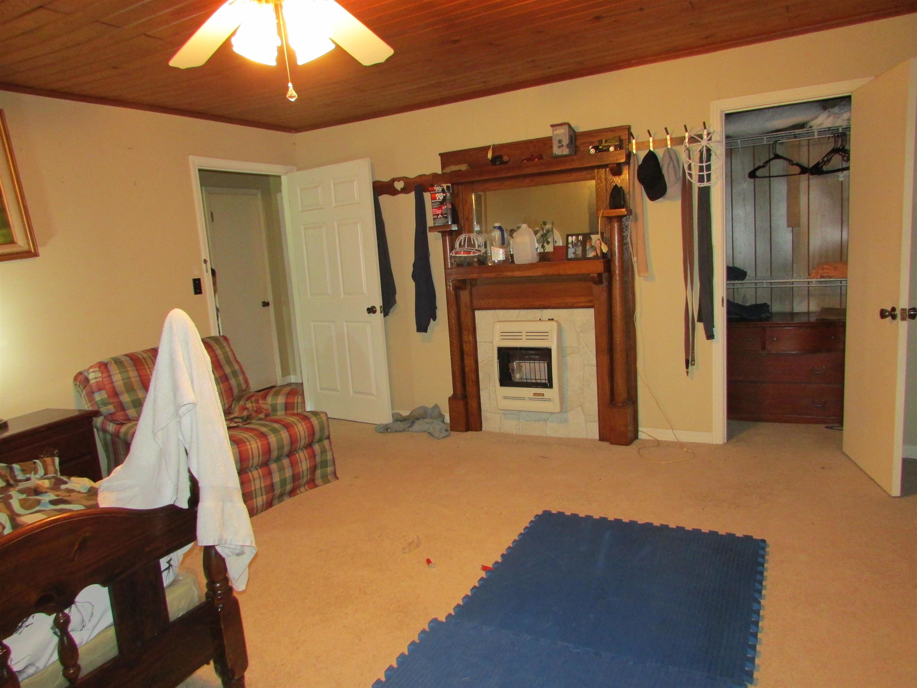 139 Plunk Drive Adamsville, TN 38310 - Photo 10 of 25 a view of a livingroom with a fireplace and cabinet