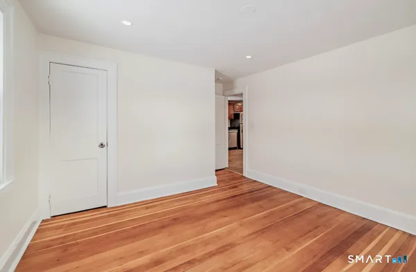 a view of room with wooden floor