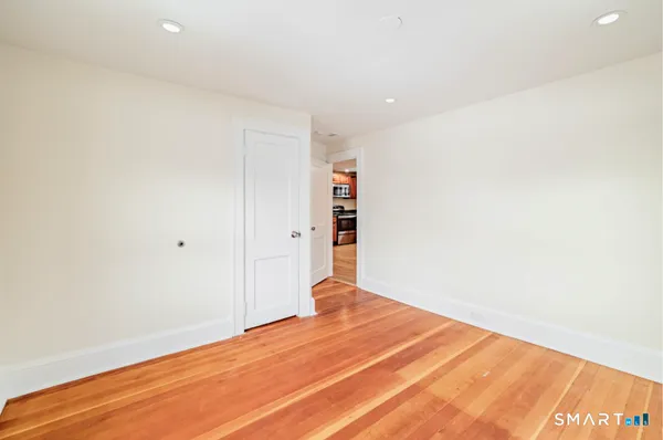 a view of a room with wooden floor