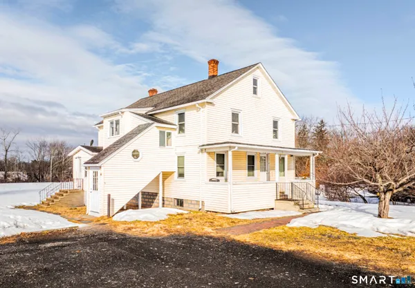 a view of a house with snow on the background
