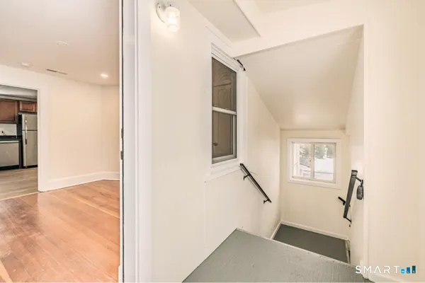 a view of entryway with wooden floor and furniture