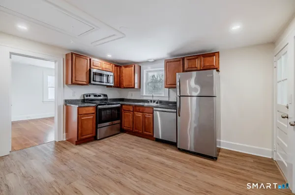 a kitchen with stainless steel appliances a refrigerator and a stove top oven