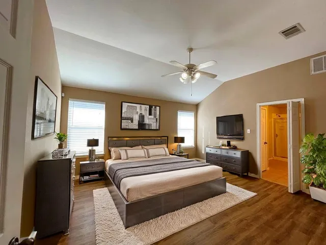 a bedroom with a bed a couch and dresser