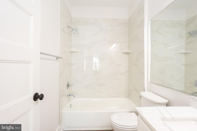 a view of a hallway with wooden floor and entryway