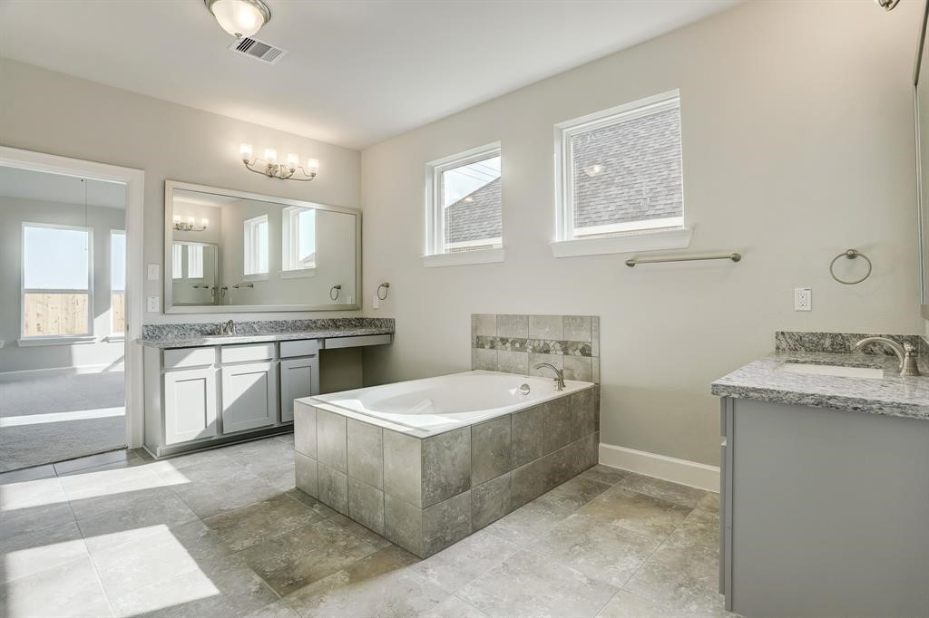 12923 Lott Avenue Houston, TX 77089 - Photo 14 of 23 a large white bathroom with a sink a bathtub and a mirror