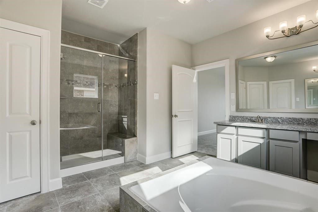 12923 Lott Avenue Houston, TX 77089 - Photo 15 of 23 a spacious bathroom with a shower sink and mirror