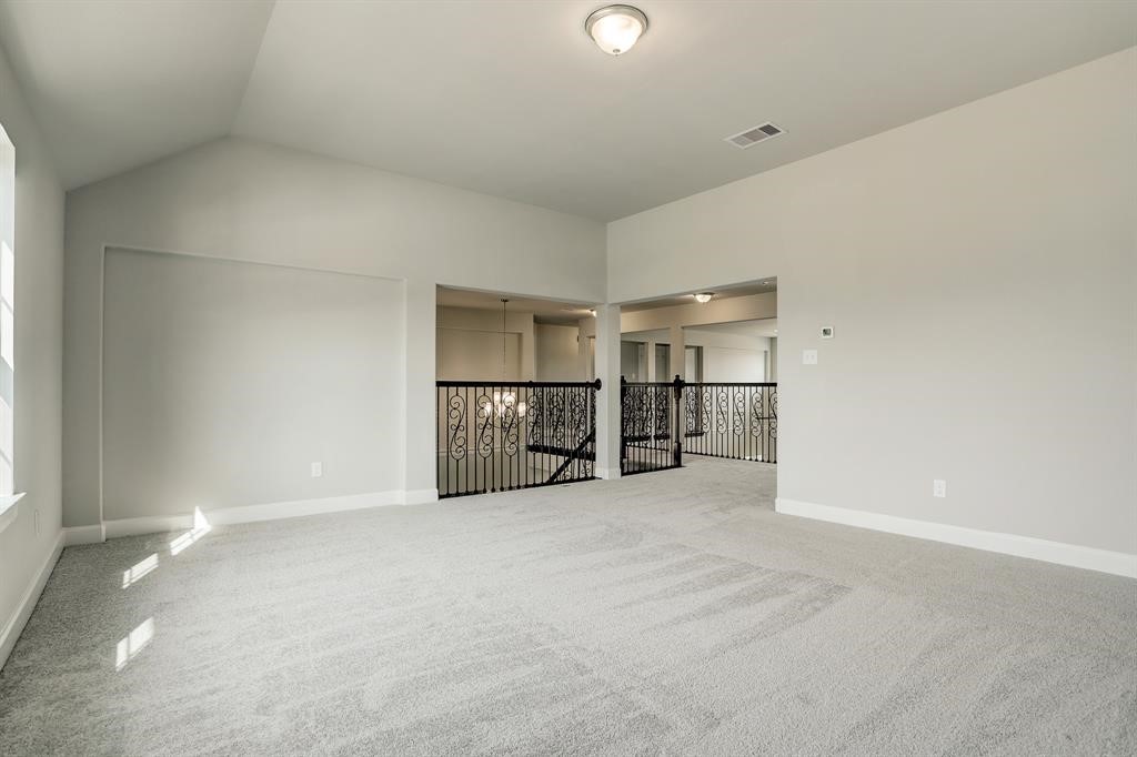 12923 Lott Avenue Houston, TX 77089 - Photo 19 of 23 an empty room with chandelier fan and windows
