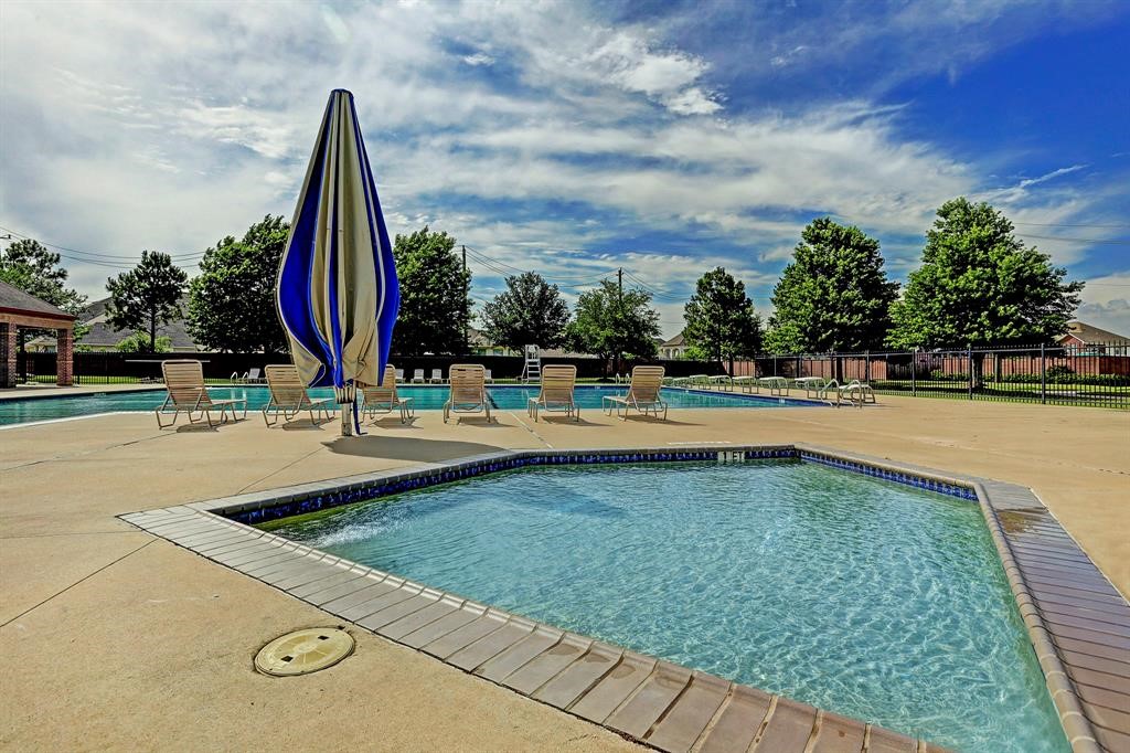 12923 Lott Avenue Houston, TX 77089 - Photo 22 of 23 a view of a swimming pool with a sitting space