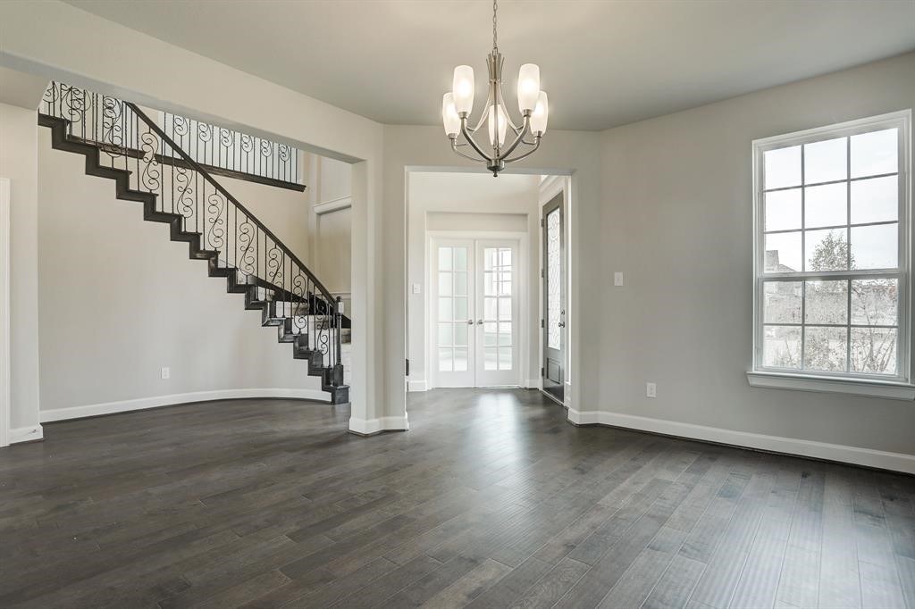 12923 Lott Avenue Houston, TX 77089 - Photo 4 of 23 a view of empty room with wooden floor chandelier and windows