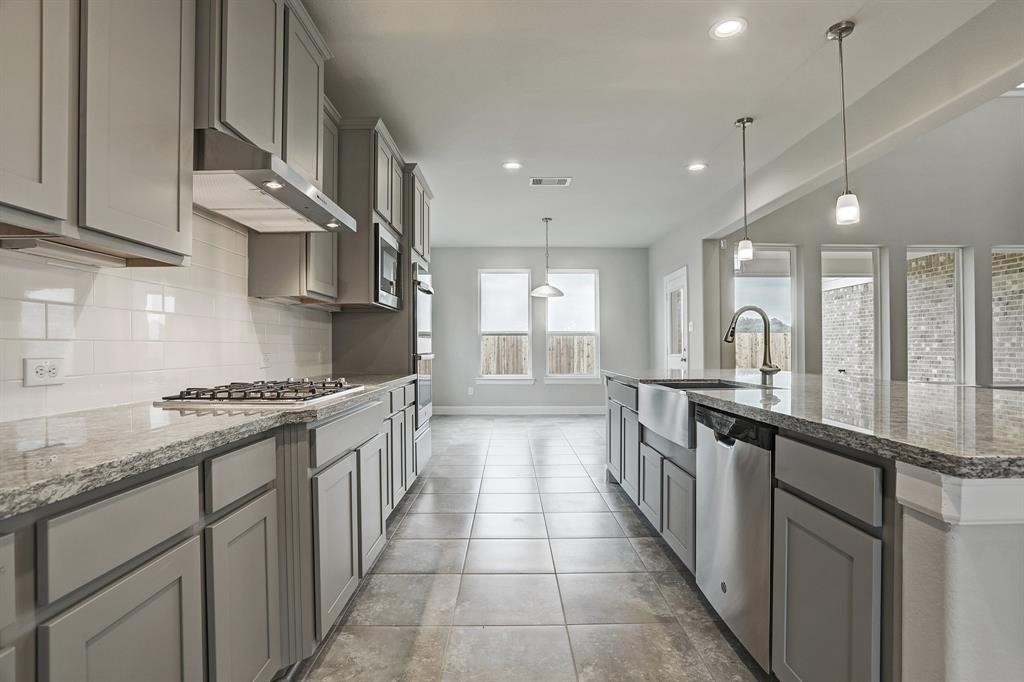 12923 Lott Avenue Houston, TX 77089 - Photo 5 of 23 a large kitchen with stainless steel appliances granite countertop a sink and cabinets