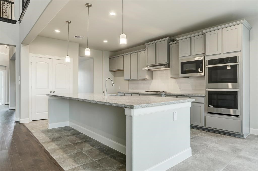 12923 Lott Avenue Houston, TX 77089 - Photo 6 of 23 a kitchen with kitchen island granite countertop a stove and a sink with granite countertops