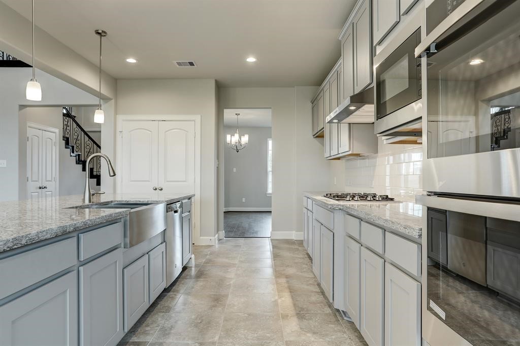 12923 Lott Avenue Houston, TX 77089 - Photo 7 of 23 a kitchen with stainless steel appliances granite countertop a stove a sink and a refrigerator