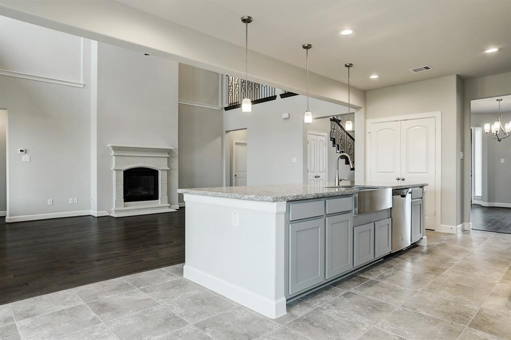 12923 Lott Avenue Houston, TX 77089 - Photo 8 of 23 a kitchen with white cabinets and a fireplace