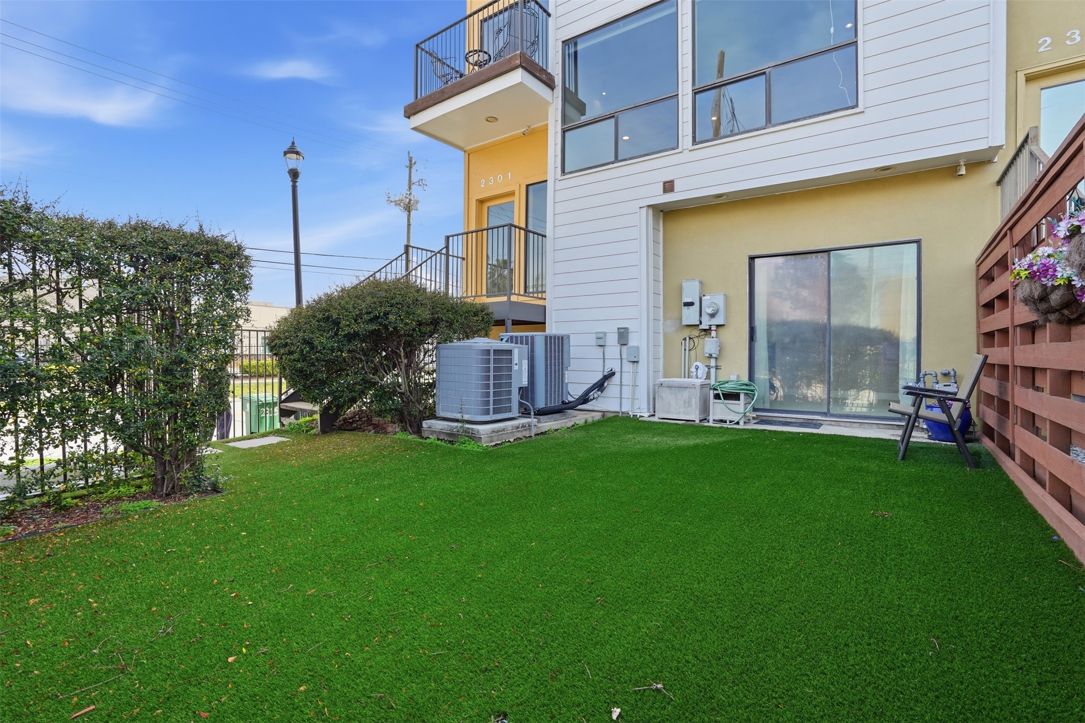 Enjoy a fenced-in private yard lined with privacy bushes, creating the perfect setting to relax or entertain. The private gate access offers added convenience and endless possibilities for outdoor living.