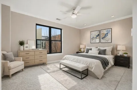 a spacious bedroom with a bed and window