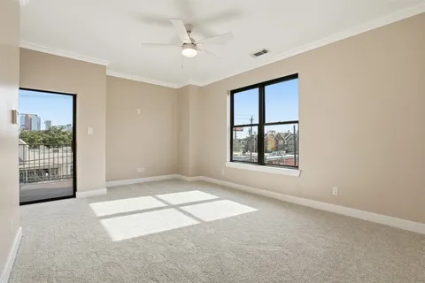 an empty room with windows and closet