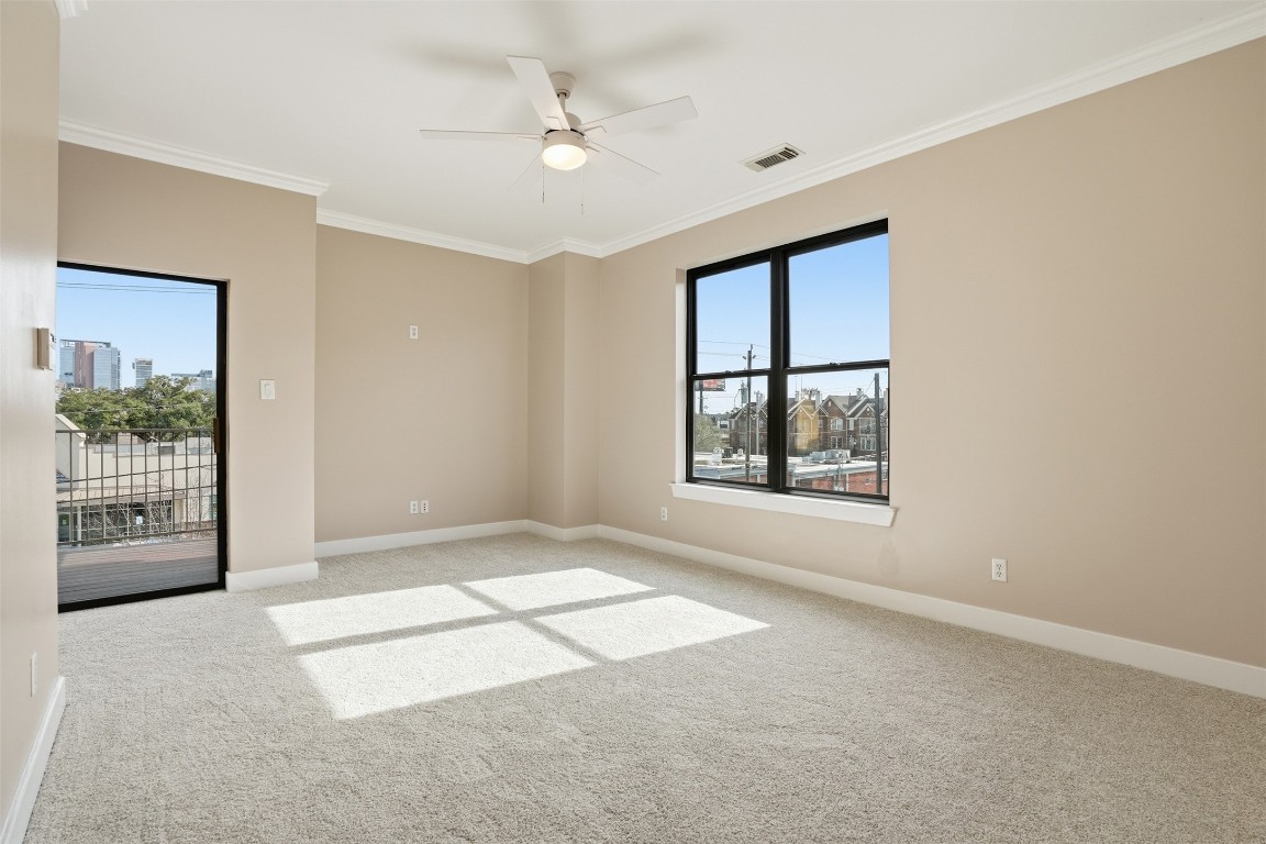 2301 Crawford Street Houston, TX 77004 - Photo 19 of 32 Primary Suite: A spacious retreat with unbeatable downtown views, featuring enough room for a comfortable seating area. The suite offers both north and east exposures and includes a private balcony, perfect for enjoying the skyline in privacy.