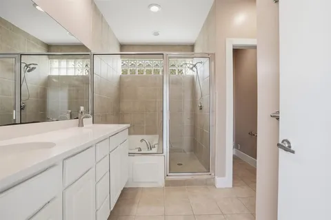 a bathroom with a shower sink and mirror