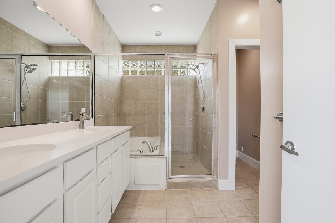 2301 Crawford Street Houston, TX 77004 - Photo 22 of 32 The primary en-suite features fresh paint, NEW vanity and a walk-in shower, and a luxurious soaking tub.
