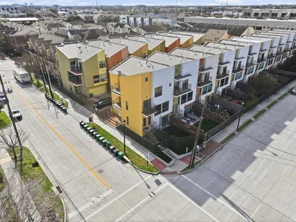 an aerial view of residential houses with outdoor space