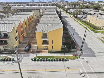 an aerial view of a residential apartment building with garage