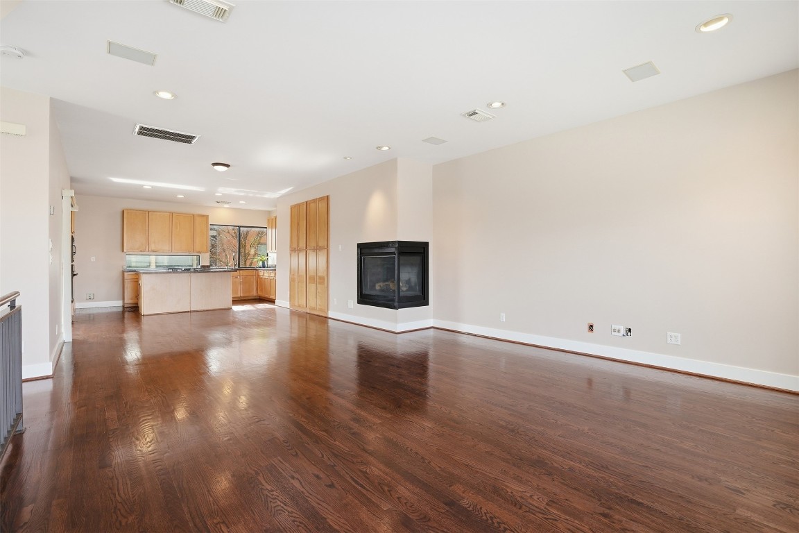 2301 Crawford Street Houston, TX 77004 - Photo 7 of 32 The open, light-filled living and kitchen area offers stunning north, east, and west views of the city. Expansive windows and multiple patio spaces flood the home with natural light, creating a bright and inviting atmosphere throughout.
