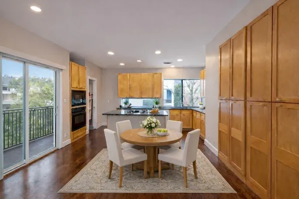 a dining room with furniture and wooden floor