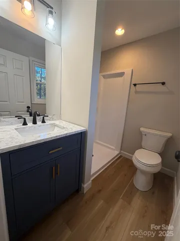 a bathroom with a sink toilet and mirror
