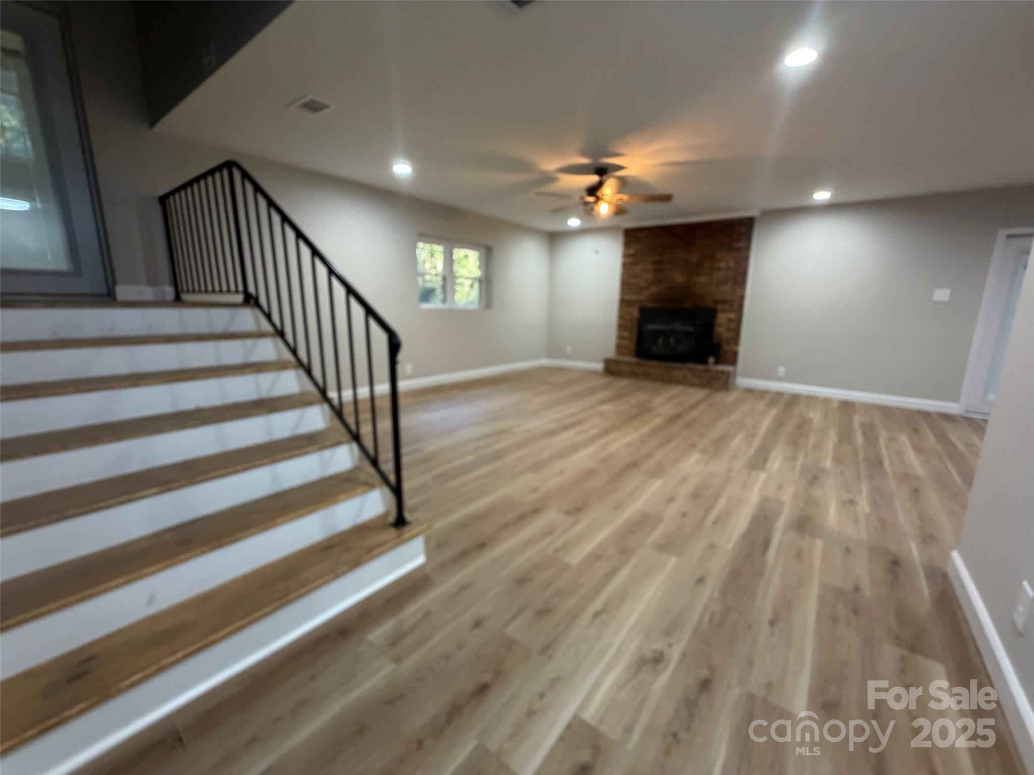 1470 Requa Road Cherryville, NC 28021 - Photo 5 of 28 wooden floor in an empty room with a fireplace