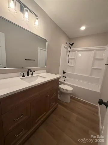 a bathroom with a double vanity sink toilet and shower