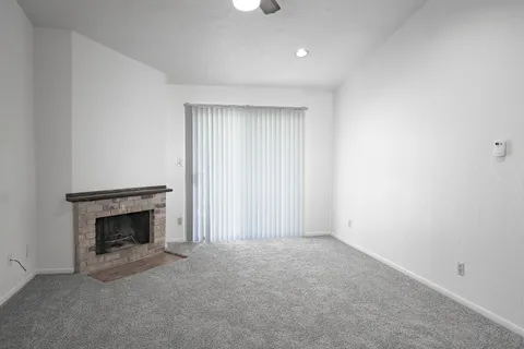 a view of empty room with fireplace