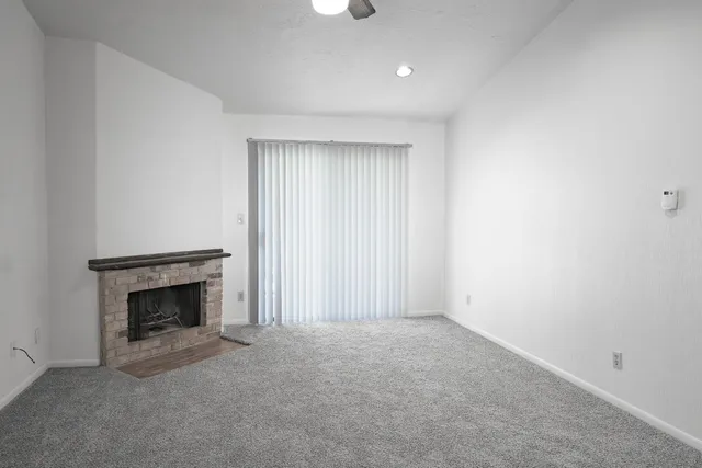 a view of empty room with fireplace