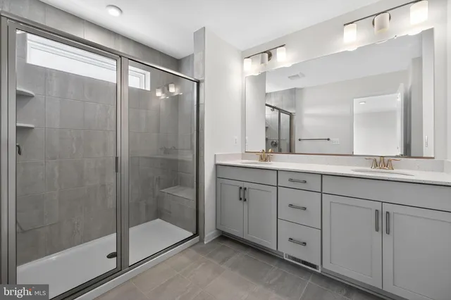 a bathroom with a shower sink and mirror