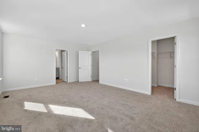 a view of an empty room with closet area