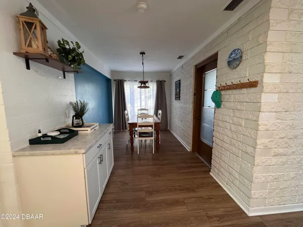 a kitchen with granite countertop a stove a sink and a refrigerator