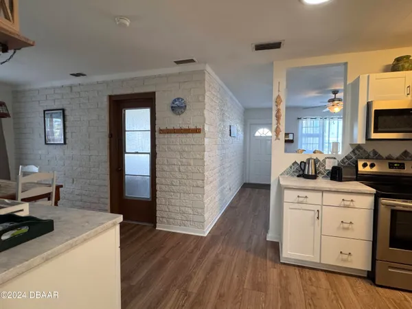 a kitchen with sink cabinets and wooden floor