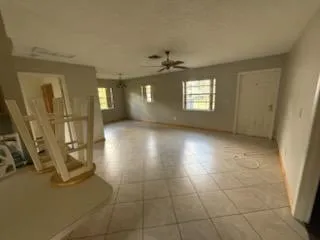 a view of livingroom with hardwood floor and a ceiling fan