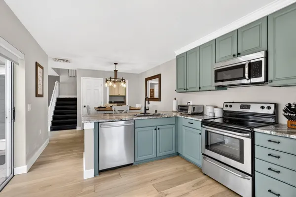 a bedroom with a large bed and a chandelier