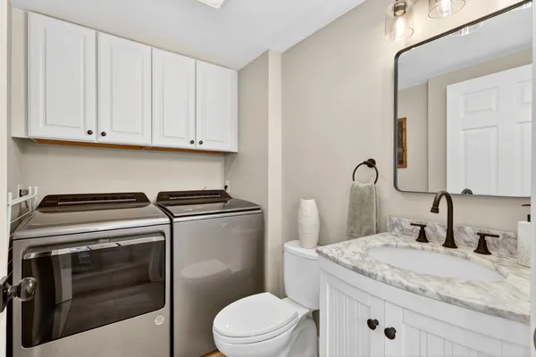a bathroom with a double vanity sink mirror and shower