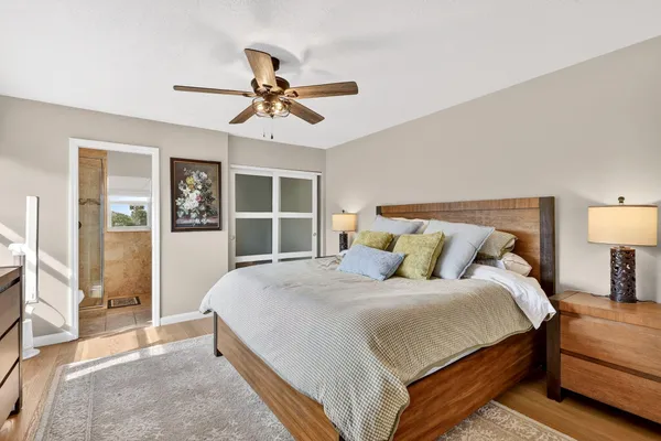 a bedroom with a bed and wooden floor