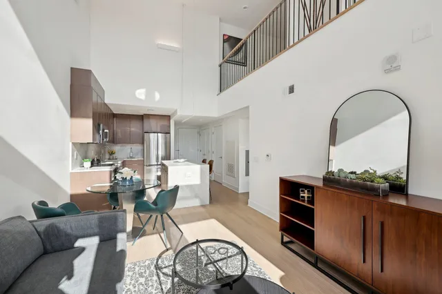 a living room with furniture a rug and a stove
