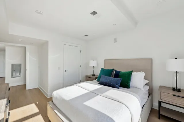 a bedroom with a bed and a lamp