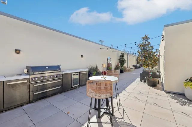 a kitchen with a stove a table and chairs in it