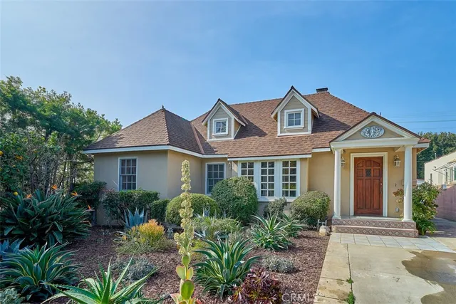 a front view of a house with garden