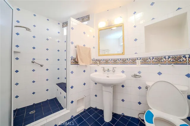 a bathroom with a sink a mirror and a shower